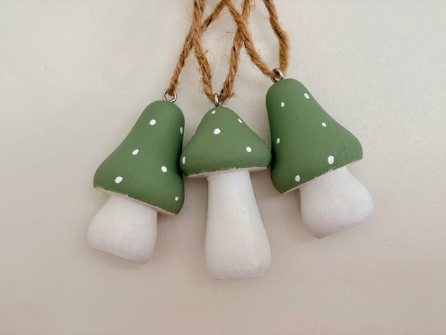 Three mushroom-shaped decorations hanging on a string