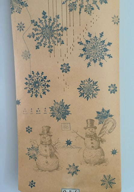 Decorative paper with blue snowflakes and snowmen on a beige background