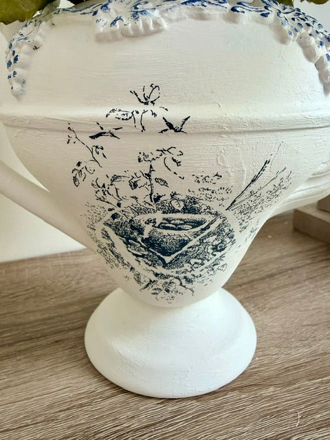 Painted white teapot with blue nest image and white faux florals