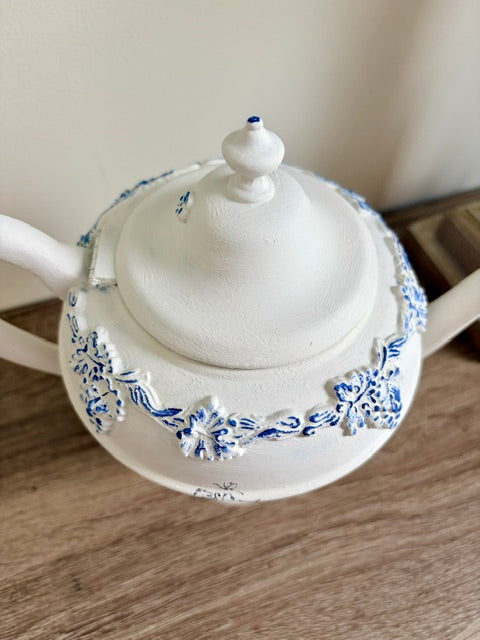 Painted white teapot with blue nest image and white faux florals