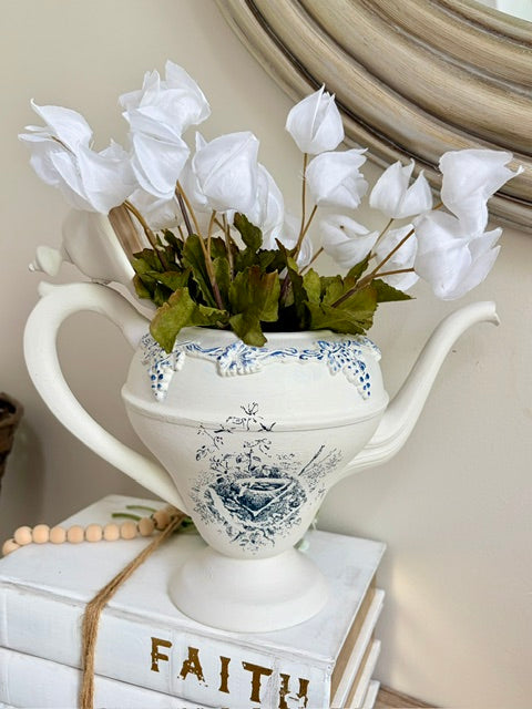Painted white teapot with blue nest image and white faux florals