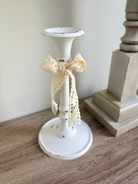 White candlestick with lace bow.