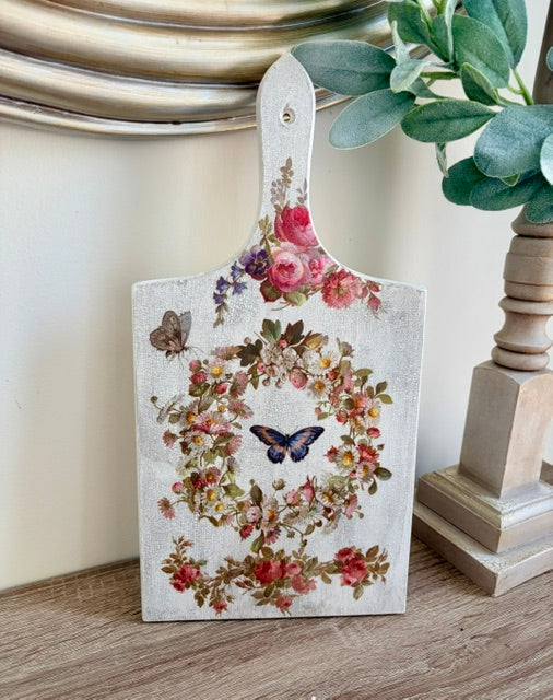 Cutting board with flowers and butterflies.