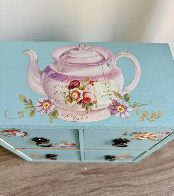 Close up of top of tea chest with teapot transfer.