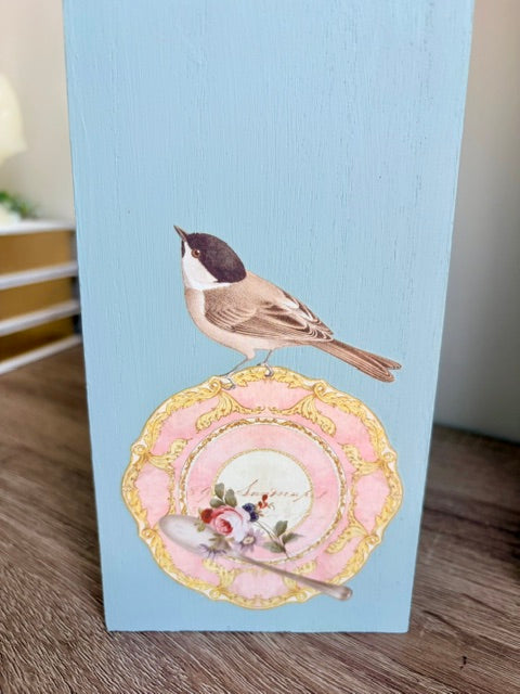 Close up of tea saucer with bird transfer.