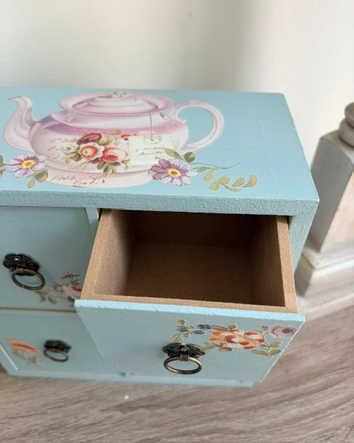 Open drawer of tea chest.