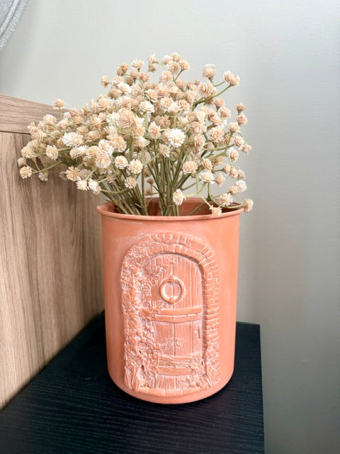 Terracotta vase with clay door and faux florals