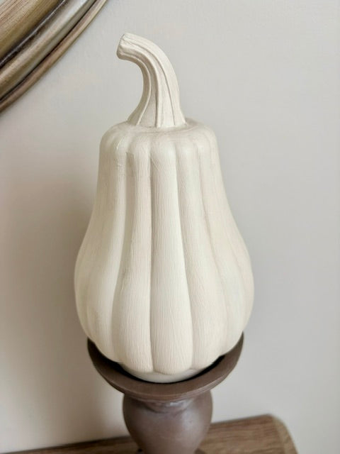 Close up of a cream painted pumpkin.