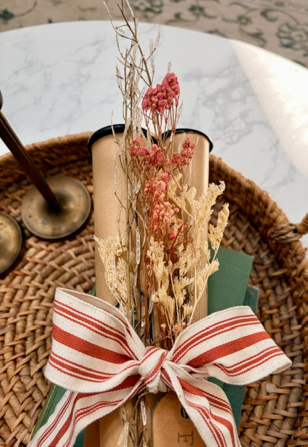 Close up of dried florals and striped bow.