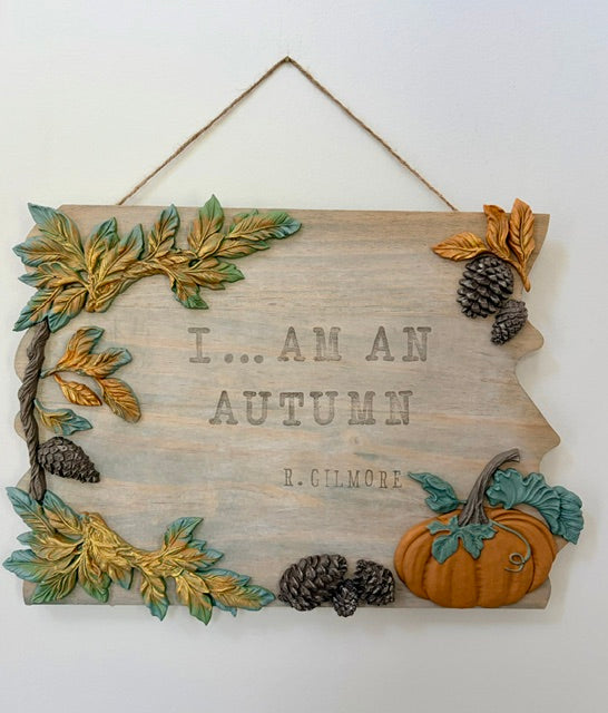 A rustic autumn-themed wooden wall sign with the text 'I am an autumn.  R. Gilmore"