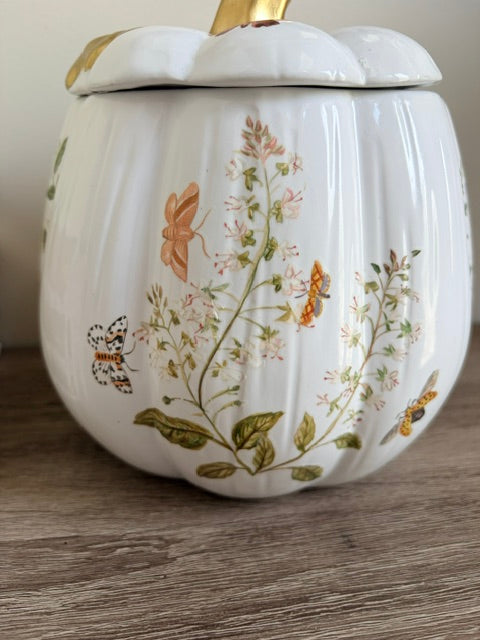 Floral designs on a white ceramic pumpkin.
