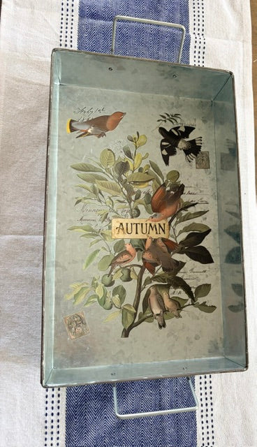 Metal tray with handles and autumn themed image on the inside.