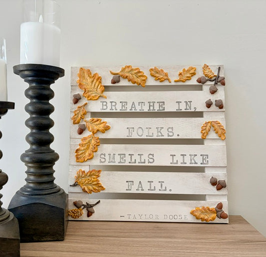 Fall sign with yellow oak leaves and acorns, and the phrase "Breathe in, folks. Smells like fall. Taylor Doose"