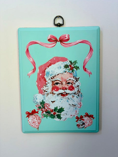 Vintage Santa plaque with red ribbon and ornament details.