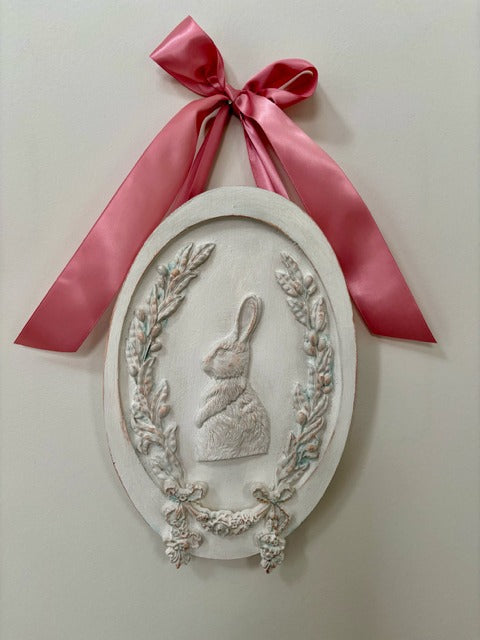 Decorative wall plaque with a rabbit silhouette and pink ribbon 