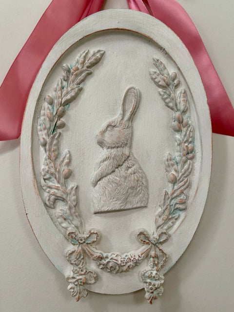 Decorative wall plaque with a rabbit silhouette and pink ribbon 