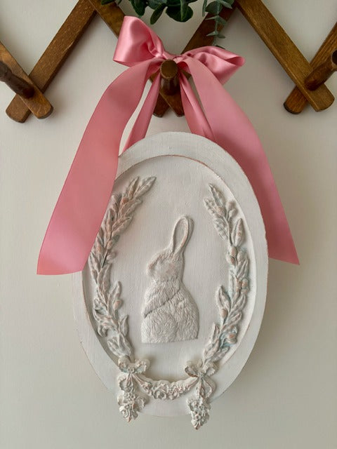 Decorative wall plaque with a rabbit silhouette and pink ribbon 