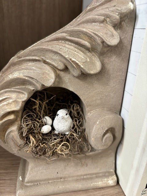 Painted corbel with a nest, bird and eggs
