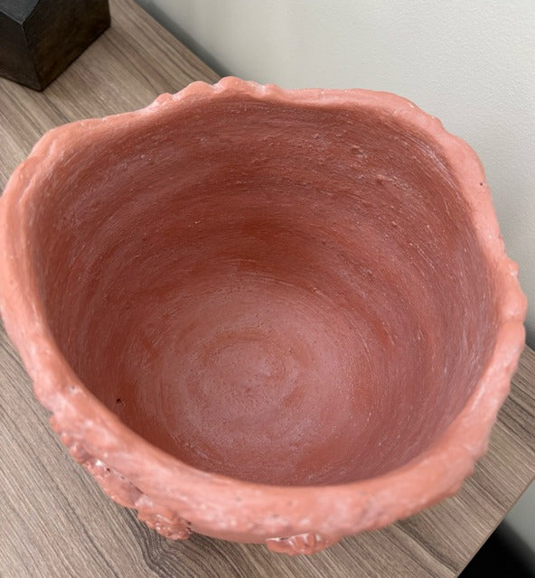 Terracotta pot on a wooden surface