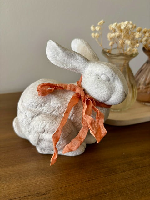 Decorative ceramic rabbit with peach ribbon