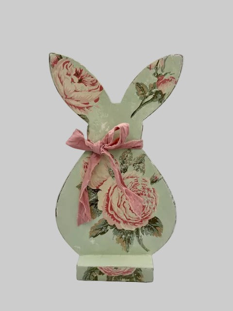 Decorative bunny figure with floral design and pink bow 