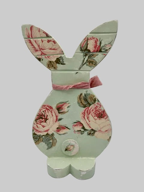 Decorative bunny figure with floral design and pink bow 