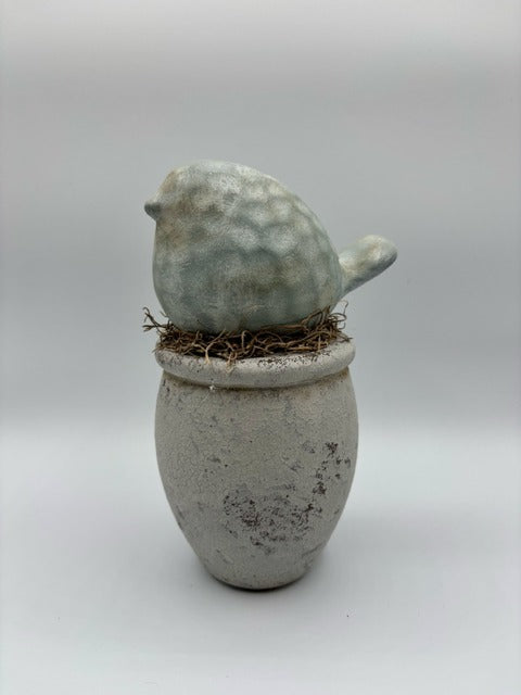 Ceramic bird on wood base