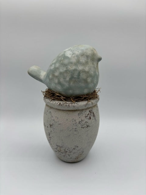 Ceramic bird on wood base