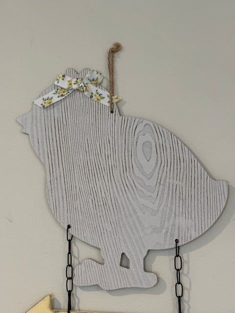 Decorative sign with a chicken silhouette and 'EGGS' text on a wooden arrow