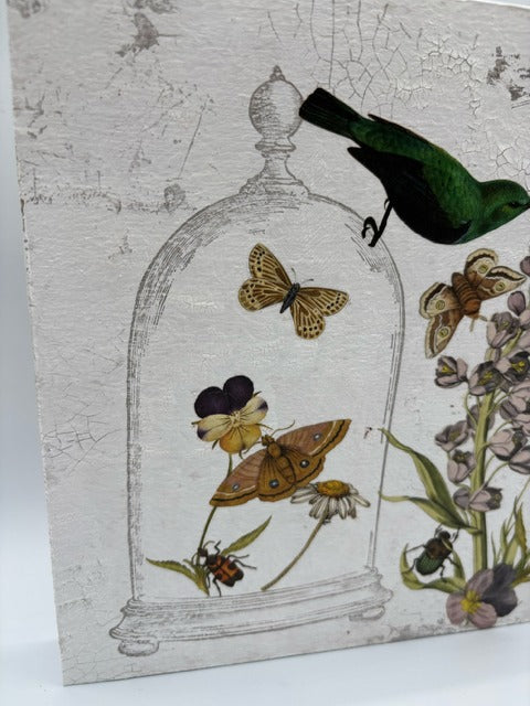 Decorative wood panel with butterflies, flowers, and a bird on a white, textured background