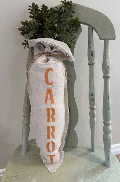 Plush fabric carrot with "carrot" stenciled in orange