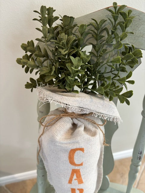 Plush fabric carrot with "carrot" stenciled in orange