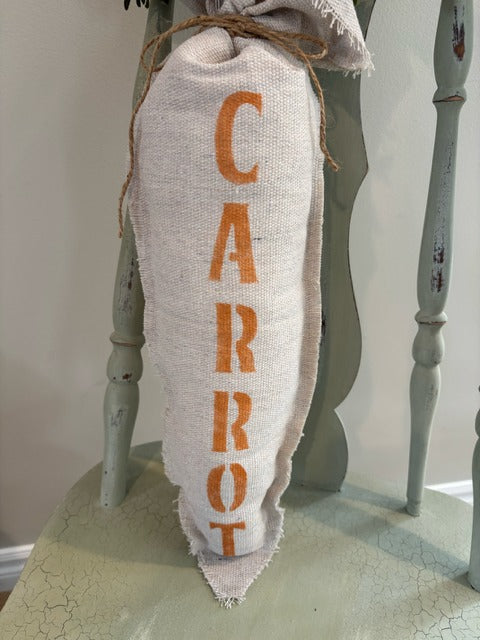 Plush fabric carrot with "carrot" stenciled in orange