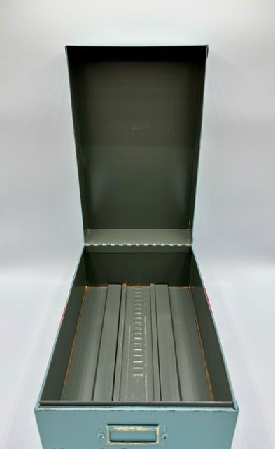 Green metal file box on a white background