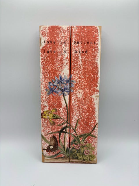 Decorative wood panel with floral design and text on a white background