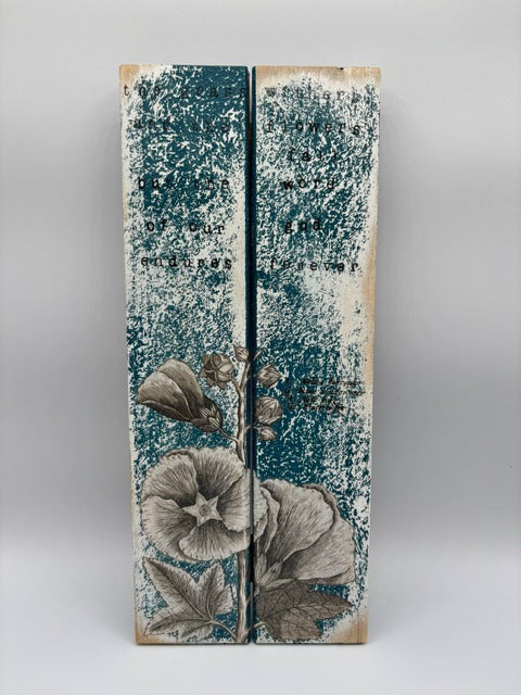 Decorative wooden panels with floral design and text on a gray background