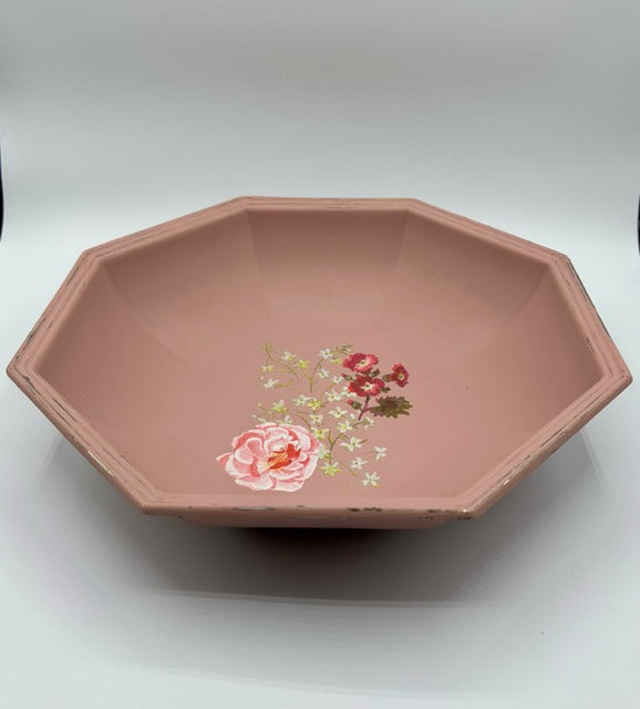 Octagonal pink dish with floral design on a white background
