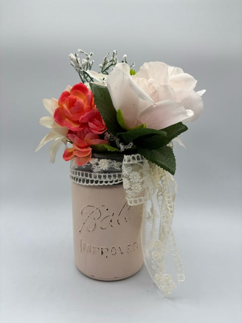 Decorative mason jar with lace and flowers 