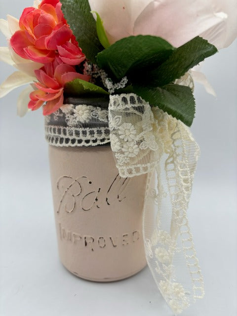 Decorative mason jar with lace and flowers 