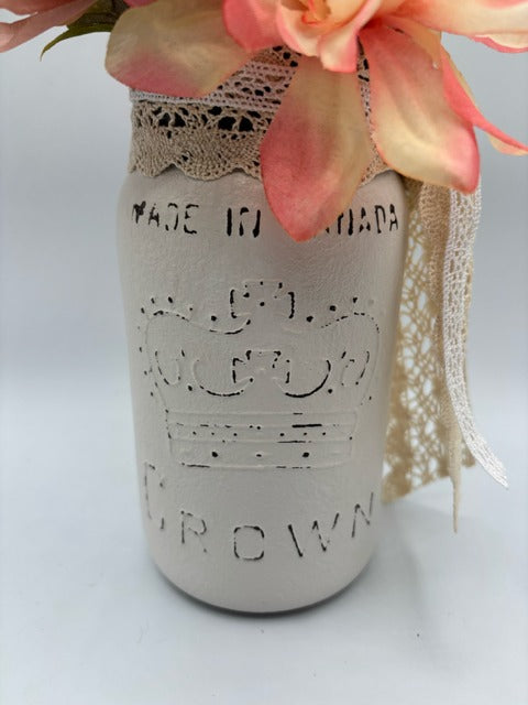 Decorative mason jar with lace and flowers 
