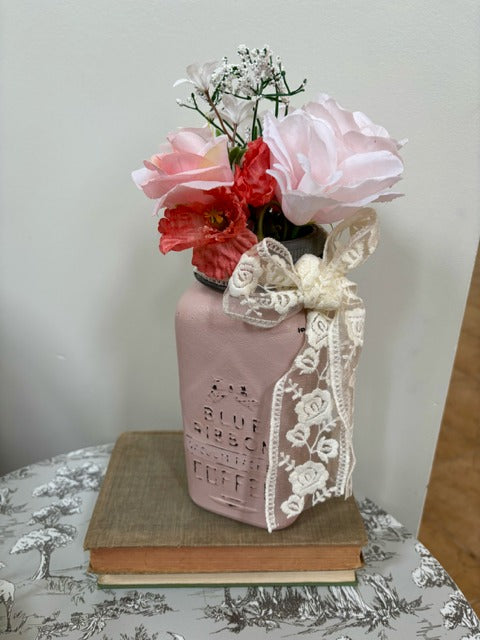 Decorative mason jar with lace and flowers 