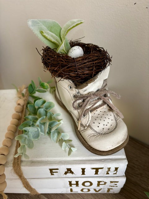 White baby shoe with a nest and eggs 