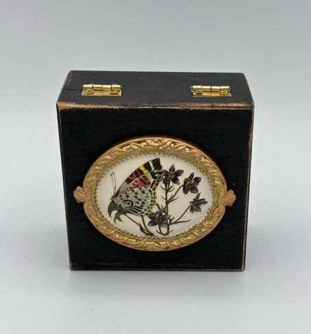 Decorative box with butterfly and floral design on a white background