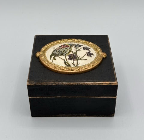 Decorative black box with floral design on a white background