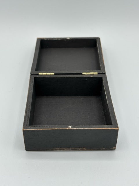 Black wooden box with a hinged lid on a white background