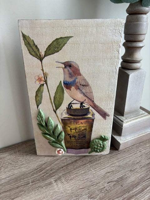 Decorative wood panel with a bird and floral design 