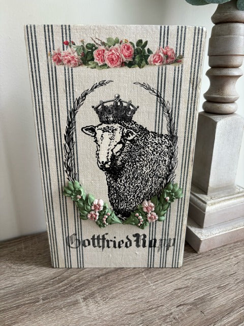 Decorative wood panel with a sheep and floral design 