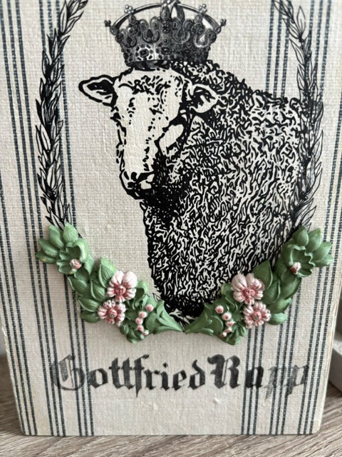 Decorative wood panel with a sheep and floral design 