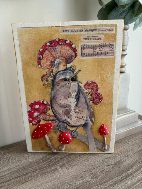 Decorative wood panel with a bird and mushroom design 
