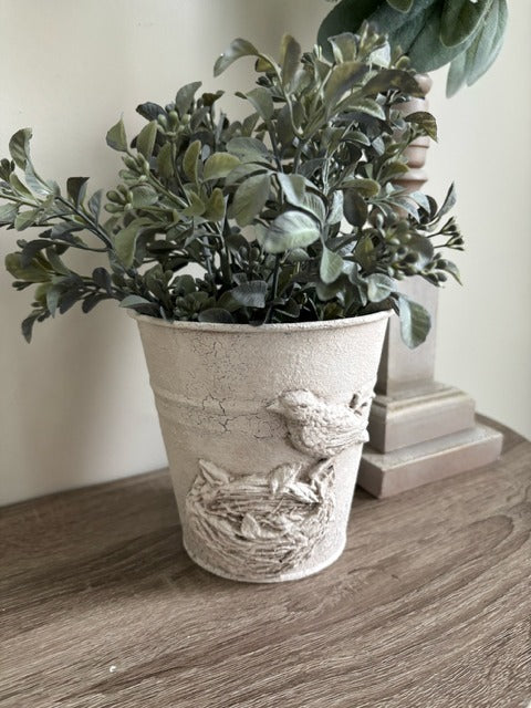 Metal pot with clay bird design and faux greenery